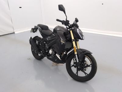 a black motorcycle parked in a room with a white wall