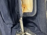 an open suitcase with a handle that is sitting on top of a table