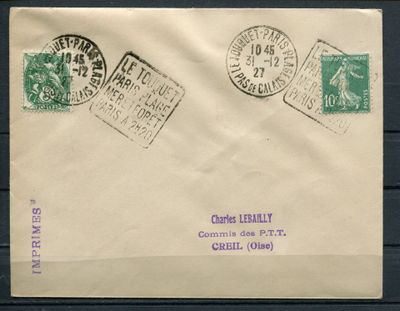 an old envelope with stamps on it sitting on a wooden surface