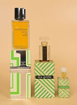a bottle of cologne next to a box of perfume