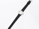 an image of a watch on a black strap on a white surface