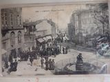 an old picture of a city street with people walking