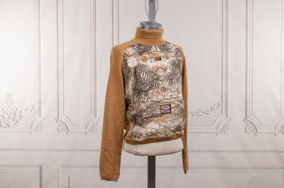 a mannequin on a stand with a sweater on it