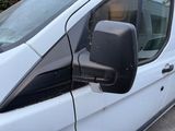 an image of a side view mirror of a white van