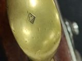 a gold spoon sitting on top of a wooden table
