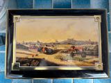 a picture of a painting on a wall above a clock