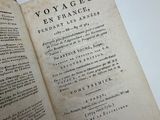 an old book with writing on it sitting on a table