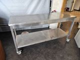 a stainless steel table on wheels in a kitchen