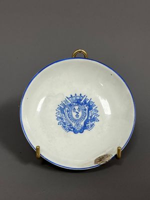 a blue and white plate with a lion on it sitting on a table