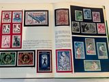 an open book with stamps on it on a table
