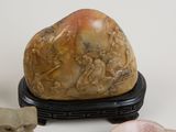 a rock with carvings on it next to other rocks