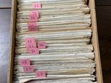 an open box filled with lots of papers sitting on top of a wooden table