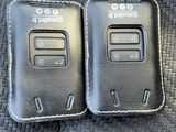 two cell phones that are sitting on the seat of a car