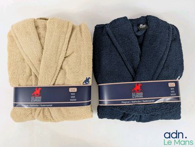 two bathrobes are lined up on a white surface