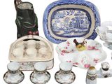 many different types of dishes and cups on the table