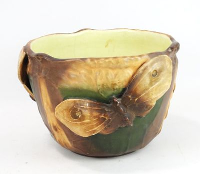 a brown and green bowl with a butterfly on it