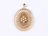 a close up of a gold pendant with pearls on a white background
