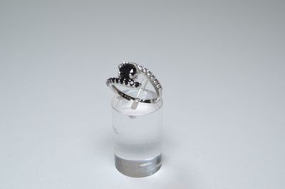 a small glass with a ring on top of it
