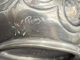 a silver vase sitting on top of a table