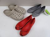 several pairs of shoes are lined up on a white surface