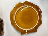 a brown plate sitting on top of a white table
