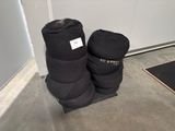 pair of black boots sitting on top of a wooden floor next to a door