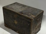 an old wooden box sitting on a white surface