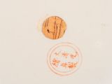 a close up of a white plate with a brown design on it