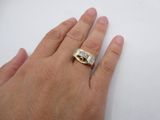 a person ' s hand with a ring on it