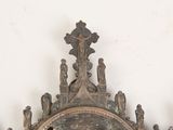 a clock that is sitting on the wall in front of a mirror
