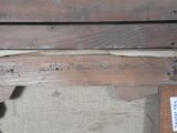 a piece of wood with writing on it and a piece of wood with writing on it