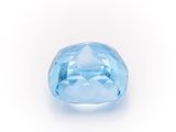 a close up of a blue diamond on a white surface