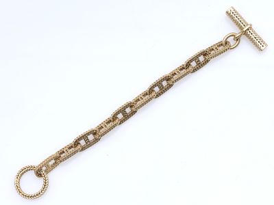 gros plan d'un bracelet en chaîne en or sur fond blanc