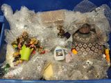 a plastic container filled with plastic toys and other items