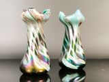 two glass vases that are sitting on a table