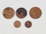 four different types of coins sitting on top of a white surface