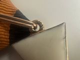 a close up of a tie bar with a triangle on it