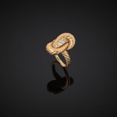 a gold and diamond ring, by person