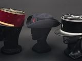three hats that are sitting on top of a mannequin head