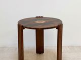 an image of a small wooden table with a flower on it