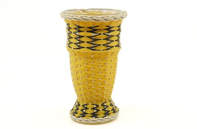 a yellow vase with a black and white design on it