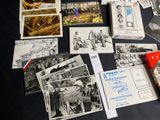 a lot of old photos and postcards on a table