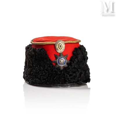 a red hat with a gold badge on it