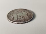 a close up of a coin on a table with a white background