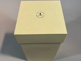 a white box with a clock on it sitting on top of a table