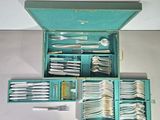 a blue box with silverware in it on a table