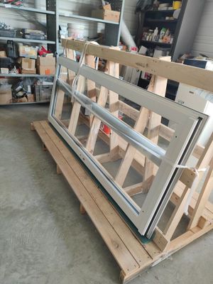 a large window that is on a pallet in a garage