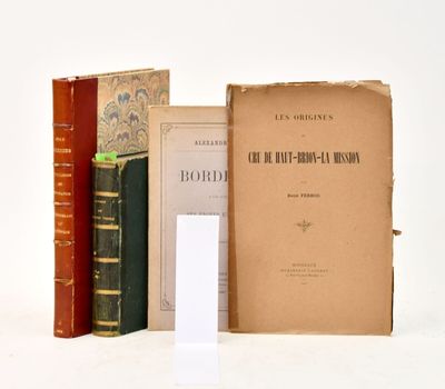 several books are stacked on top of each other on a white surface