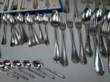 a lot of silver spoons and spoon spoons on the table