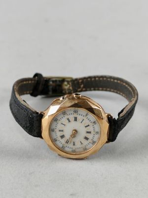 an image of a close up of a wrist watch on a white surface